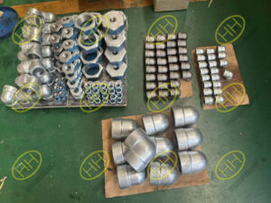 ASTM A105 threaded fittings including hot dip galvanized reducing bushings and threaded elbows prepared for shipment